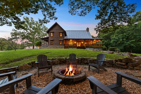 Gather around the fire pit as the whole cabin glows behind you.