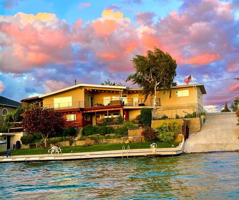 View of house from the lake during a lovely sunset.