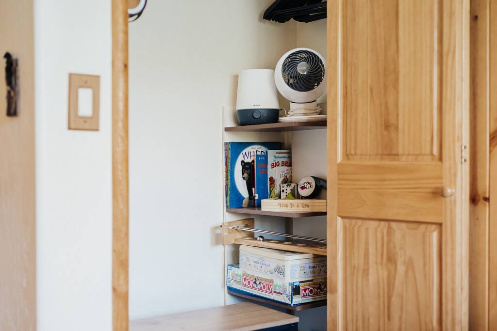The secondary bedroom closet has an assortment of reading books and games.