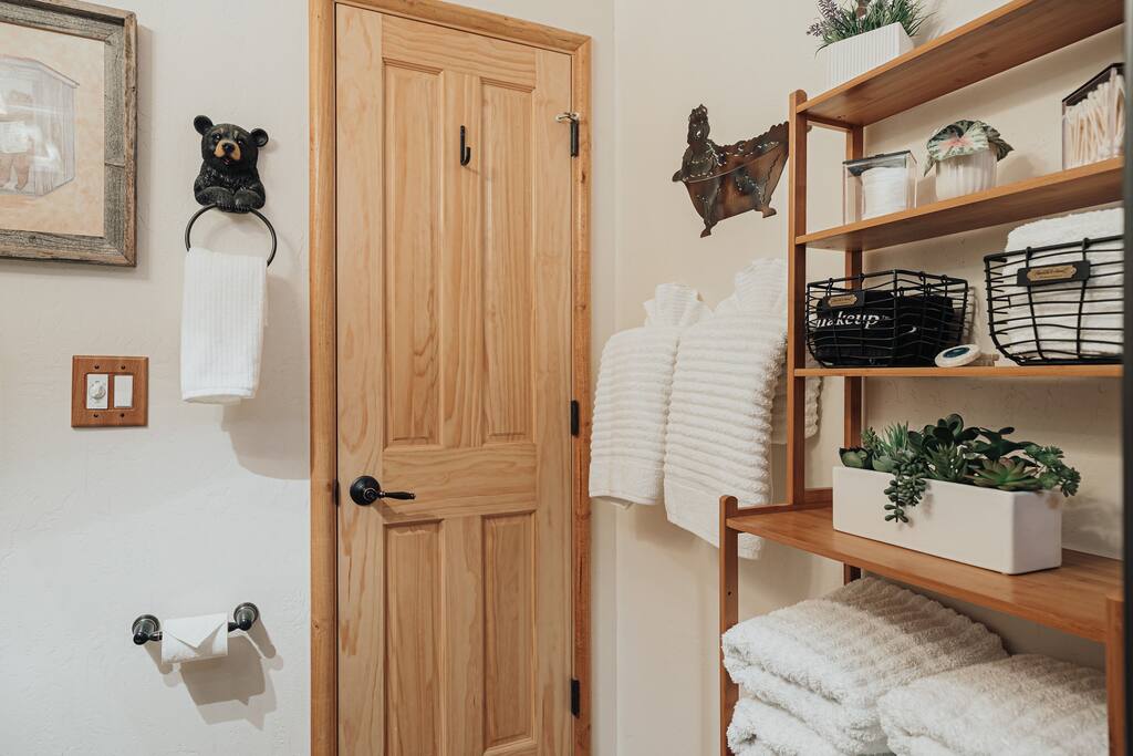 Luxury hygrocotton bathroom towels, Q-tips, cotton rounds, and black makeup towels.