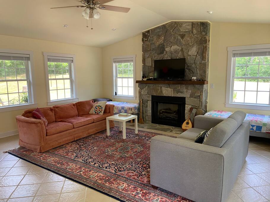 The living room offers entertainment and comfort. - Cozy Stone Cottage Near Philpott Lake  - Henry