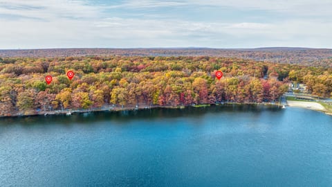 The vibrant colors of the trees surrounding the lake create a symphony of reds, oranges, and yellows, making it a true autumn masterpiece.