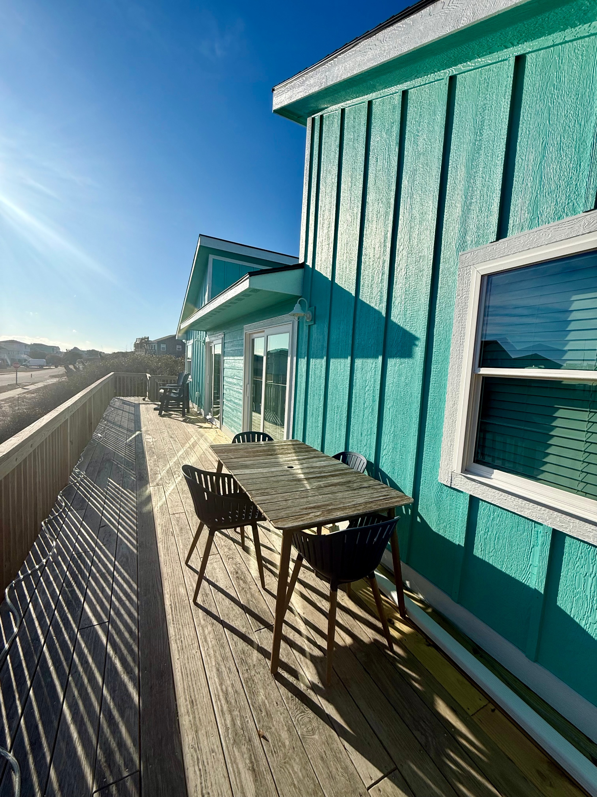 Spacious front deck with a partial ocean view