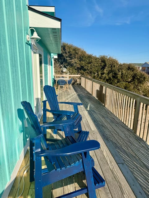 Front deck with taller chairs for extra comfort as well as a dining table.