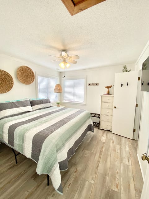 King Bedroom #1 on 18" tall bedframe. Bedside tables with individual lighting.