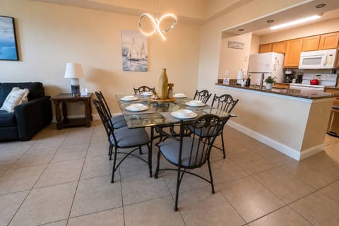 Spacious dining area with seating for six, conveniently connected to the fully equipped kitchen. Perfect for enjoying family meals together after a fun day exploring Disney and Orlando.