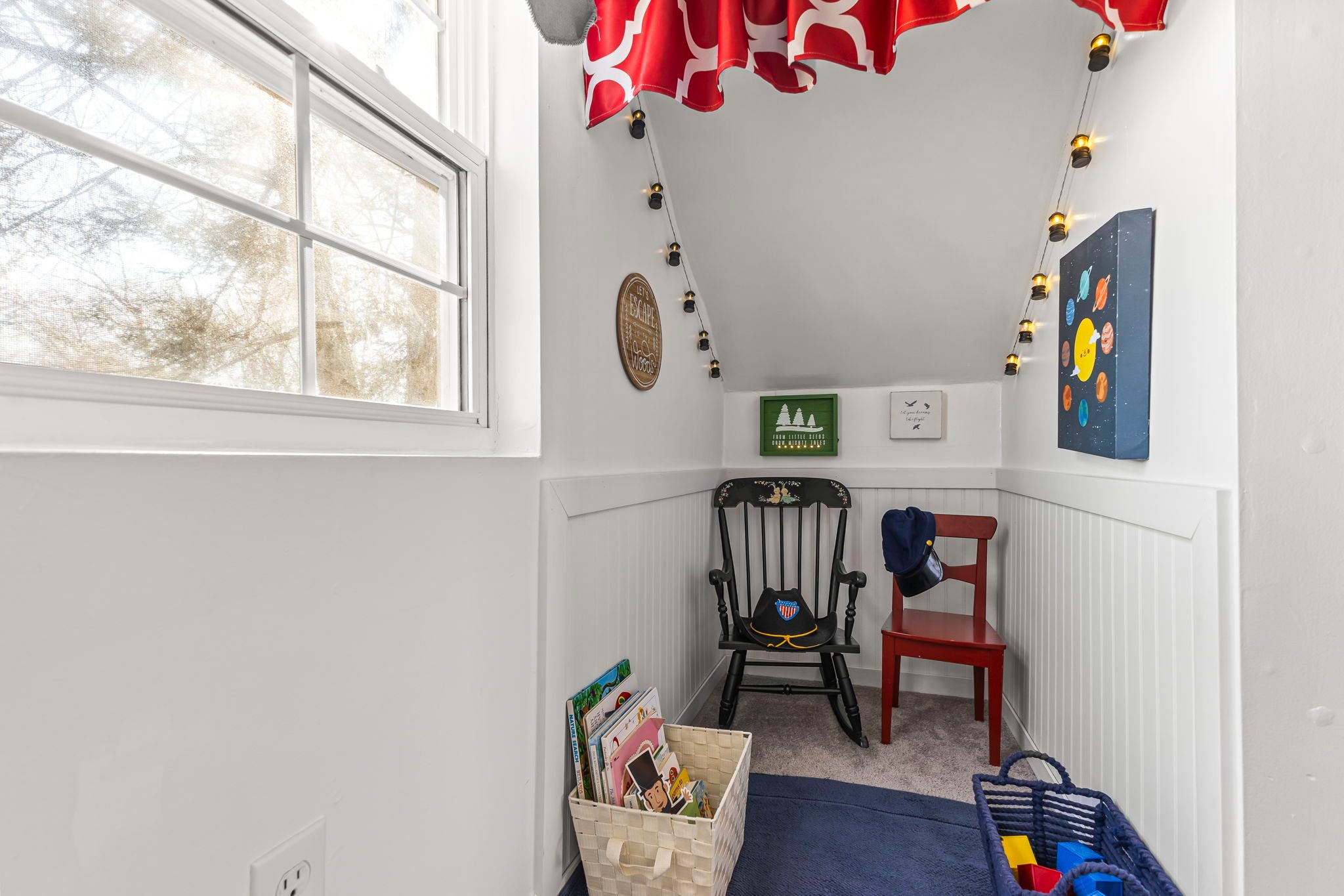 Check out this cute kids' nook under the stairs, complete with books and games. 