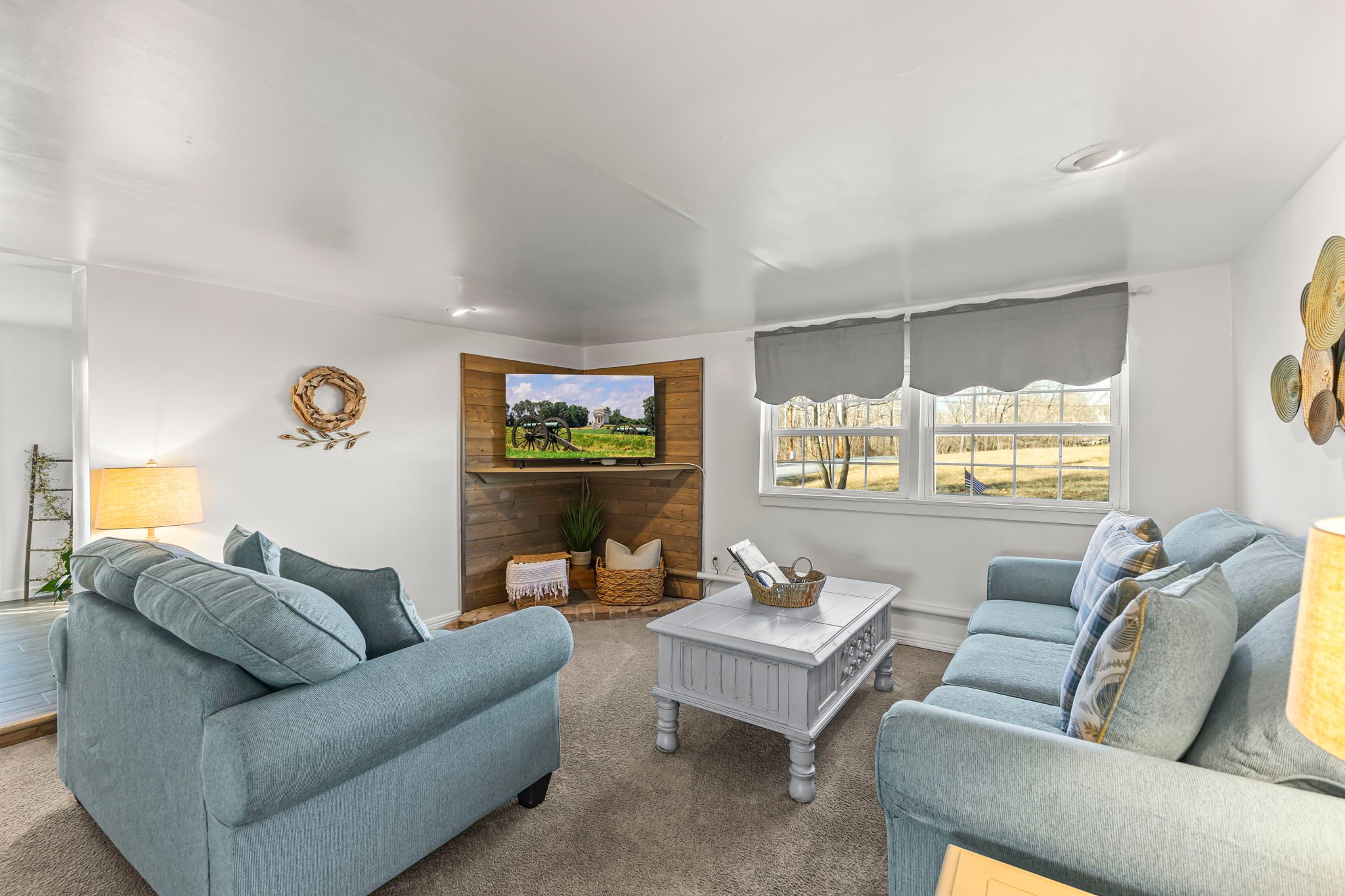 The open, airy living room has a sofa and loveseat.