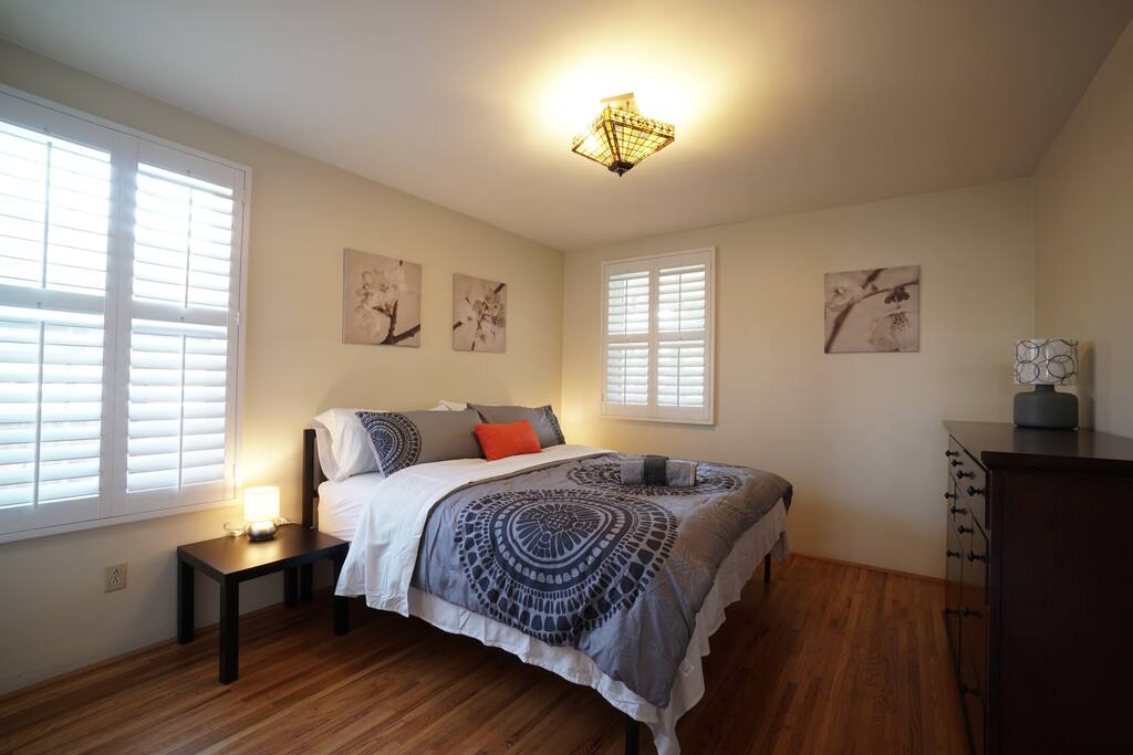 Cozy first bedroom, featuring a plush King bed and Plantation shutters that allow you to customize the amount of natural light that enters the room. Enjoy a peaceful night's rest and let in plenty of daylight to start your day off right. - House, 2 rooms, King, Queen, 1 Twin, 1.5 bath - Pasadena