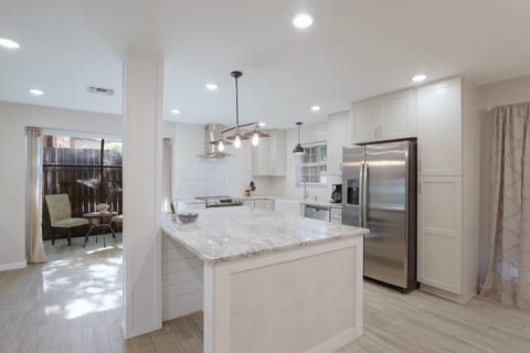 Open concept kitchen with large granite counter