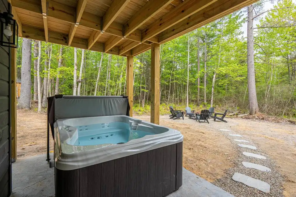 Enjoy the hot tub which has 27 jets and can easily accommodate 4 guests. - Modern Amenity A-Frame Cabin - Jay