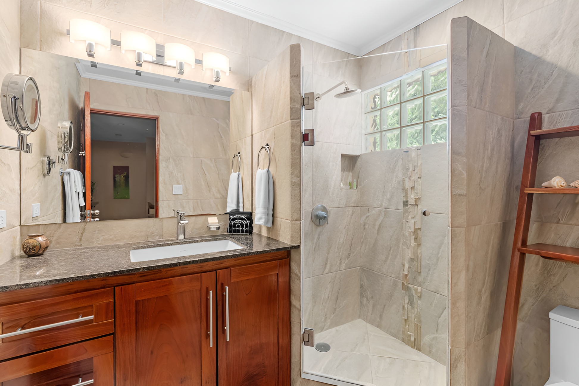 The second bathroom has ample storage and a walk in shower. 