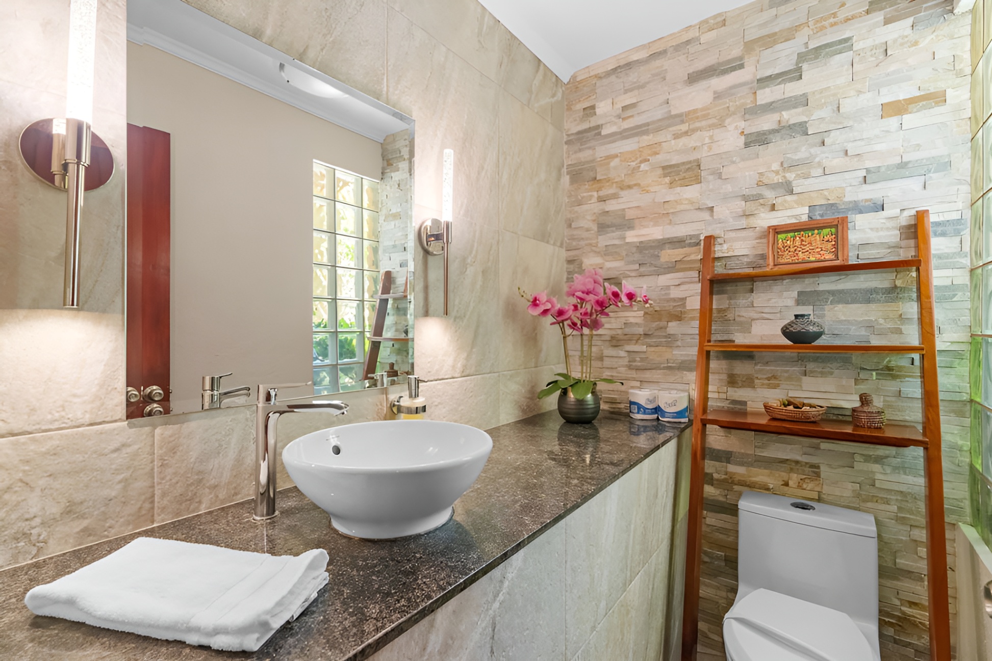 The sophisticated powder room is available on the mezzanine level, affording privacy and convenience.  