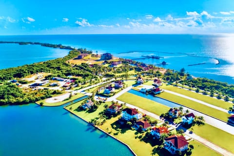 Indigo Bay in the gated waterfront community of “The Residences” with the 5-star beachfront resort and marina in the background.