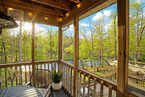 Perched up in the trees, the simply stunning raised porch is like being in a tree house, overlooking the yard and serene stream below.