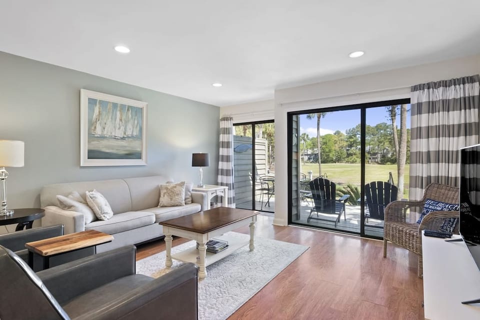 Spacious living room with view of 6th hole Galleon golf course.