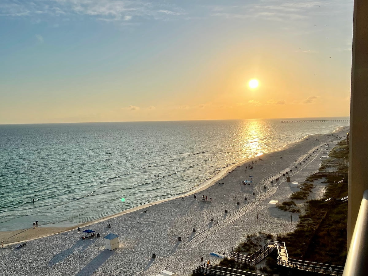 Expansive Gulf views from a large private balcony — 10th-floor beachfront 2BR.