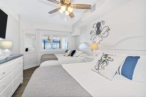- Drift into comfort in a charming bedroom with soft linens & ocean inspired decor - Two cozy queen size beds make this space perfect for families or friends to unwind together - Sleep peacefully & wake up refreshed, ready for another beach day ahead