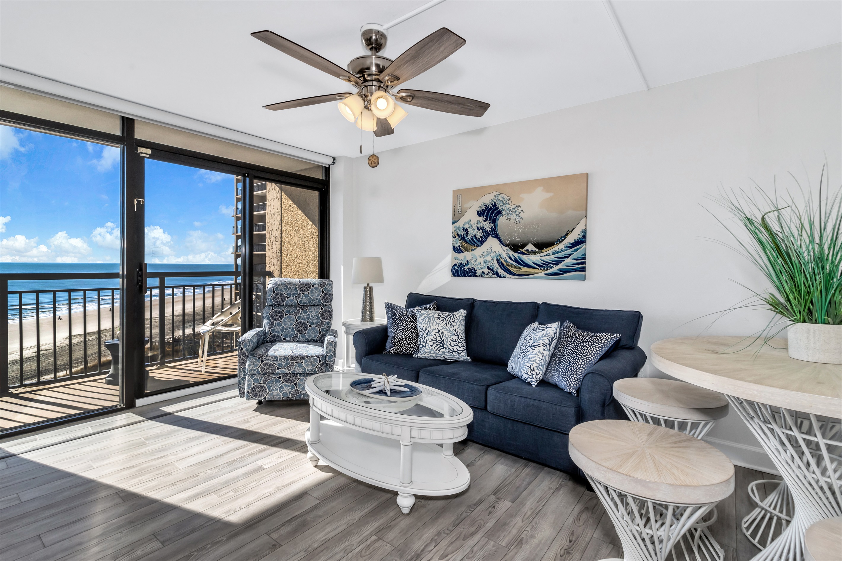 - Relax in a stylish living space with a comfy sofa and coastal-inspired decor - Floor to ceiling windows bring in endless ocean views and natural sunlight - Step onto your private balcony and take in the soothing sound of the waves
