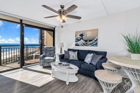 - Relax in a stylish living space with a comfy sofa and coastal-inspired decor - Floor to ceiling windows bring in endless ocean views and natural sunlight - Step onto your private balcony and take in the soothing sound of the waves