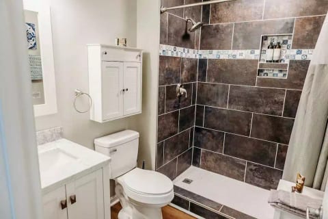 Perhaps my favorite feature of the latest renovation is the dark tile shower with Moroccan tile inset.