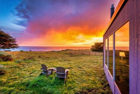"The home is positioned to enjoy both sunrise and sunset views." Oceanfront Adirondack chairs to watch orange sherbet sundowns reflect the quiet transition from day to dusk.
