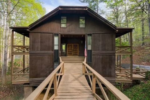 Enter the home through custom hand crafted doors made from "narrow wood" from the Philippines after crossing the bridge