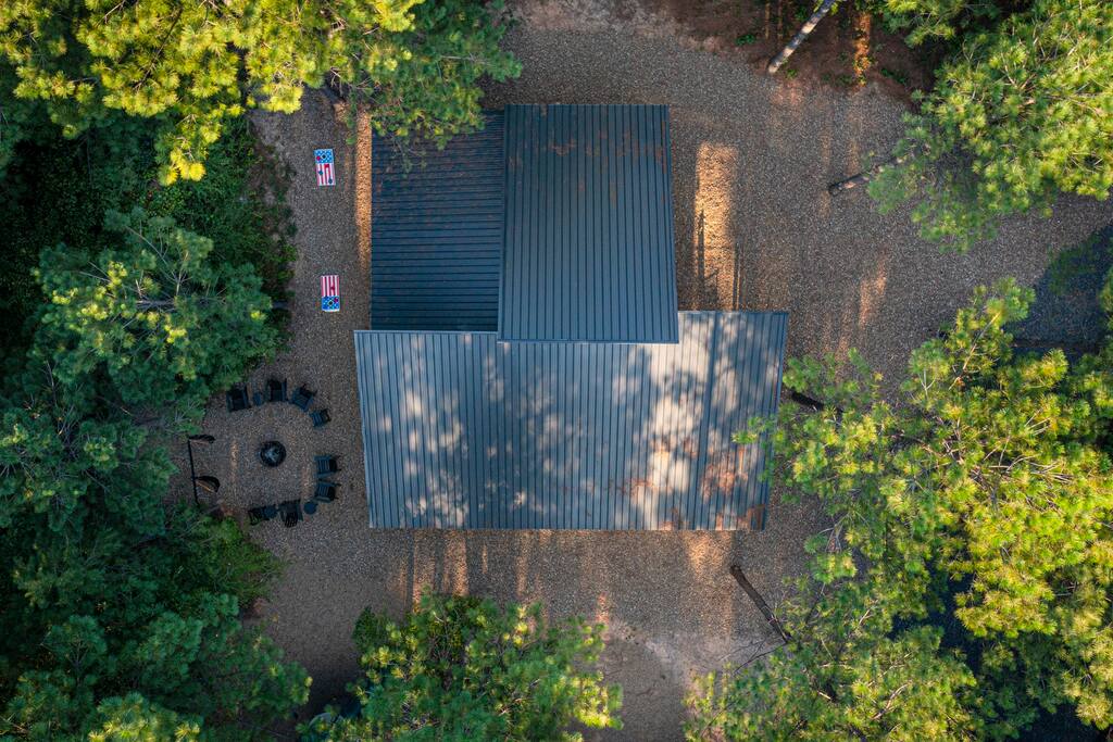 Aerial pic of cabin and surrounding woods.