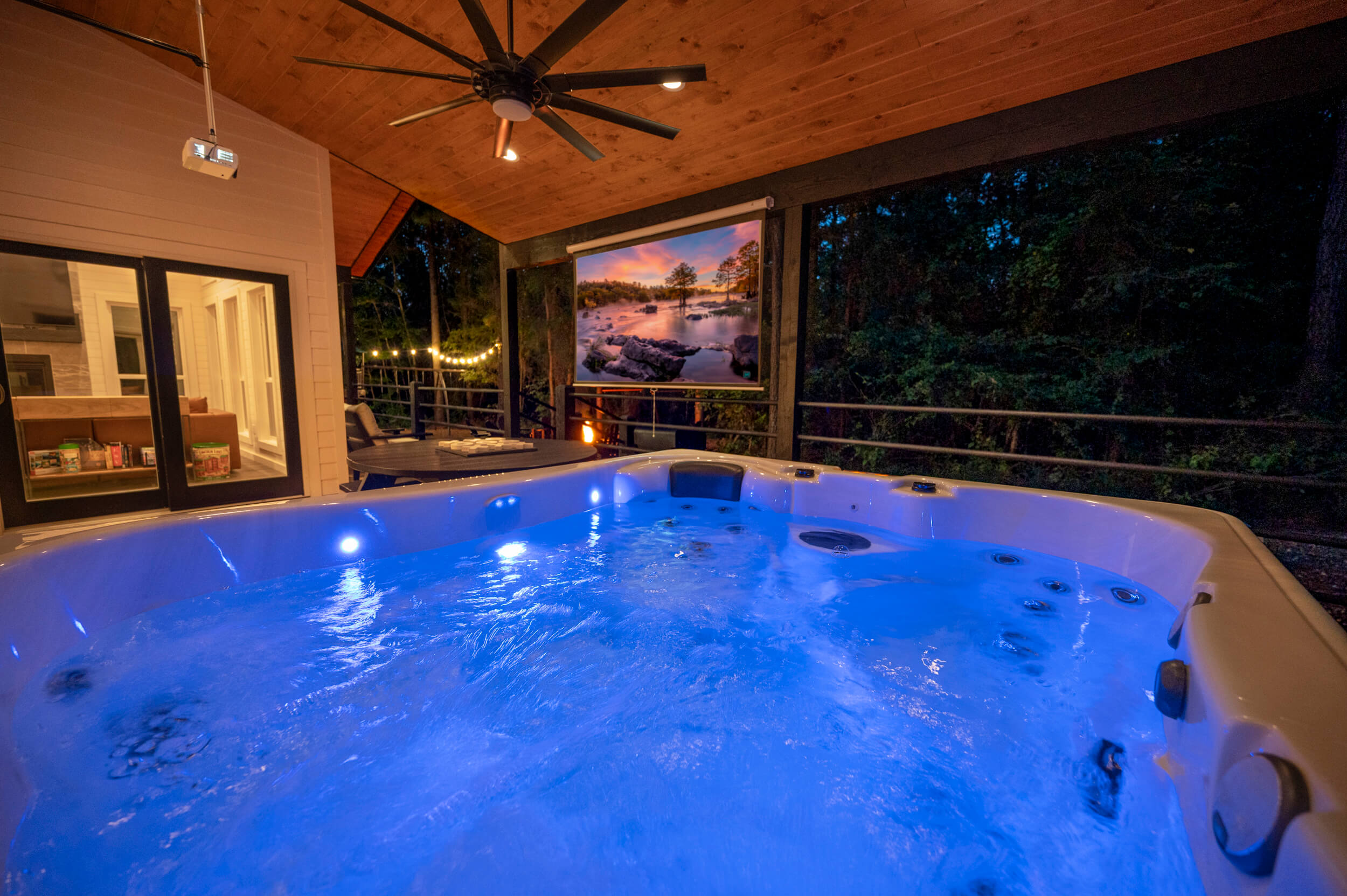 What is better than watching a movie on a 100" screen outdoors? Watching it from the hot tub of course!