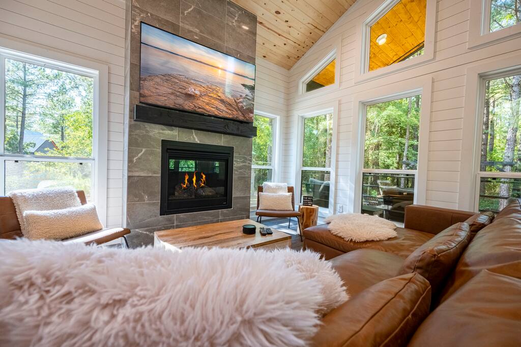 65" HD smart TV with fireplace and cozy sofa. sleeper.