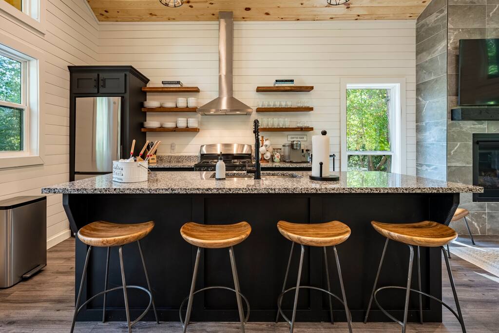 Full kitchen with stainless steel appliances.