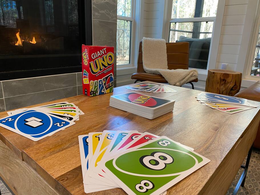 Cozy setting with Giant UNO cards by the fire, creating perfect game night vibes.