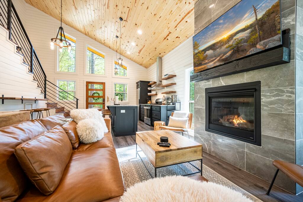 Open concept living room and kitchen area with high end furnishings.