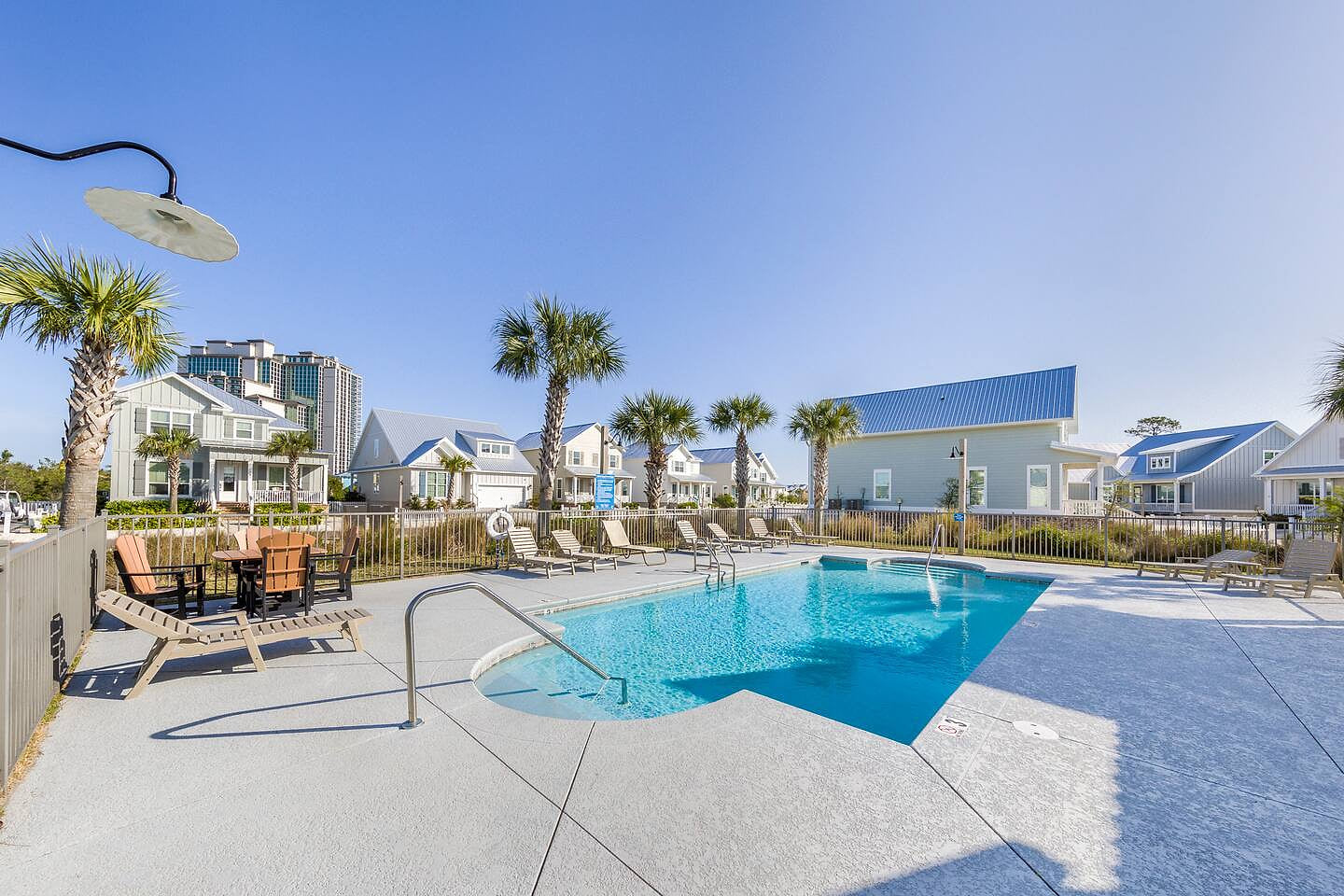 Relaxing poolside oasis with sunny skies, cozy loungers, and modern tropical charm.

