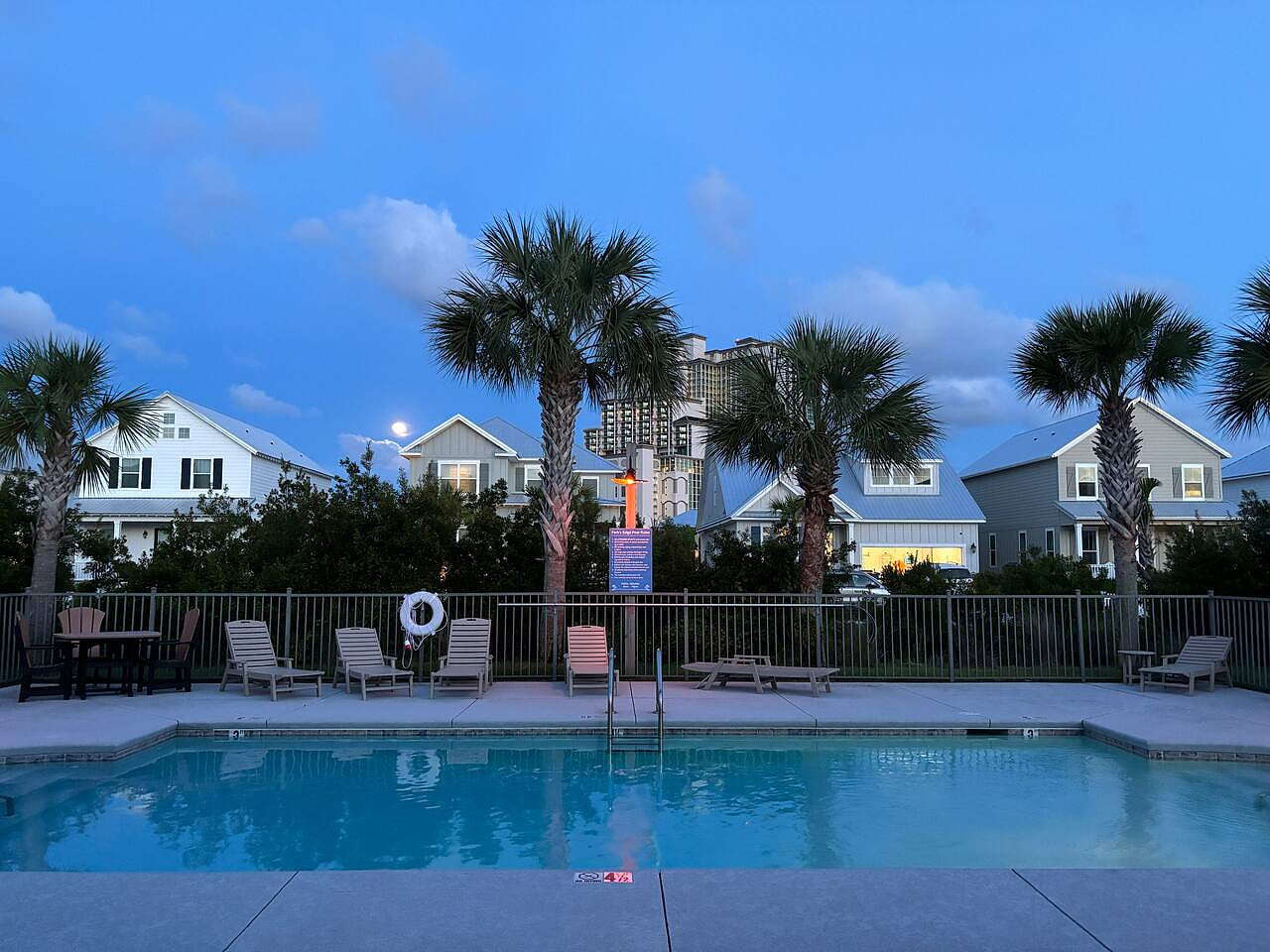 Evening swim vibes at a peaceful beach rental with palm trees and cozy charm.