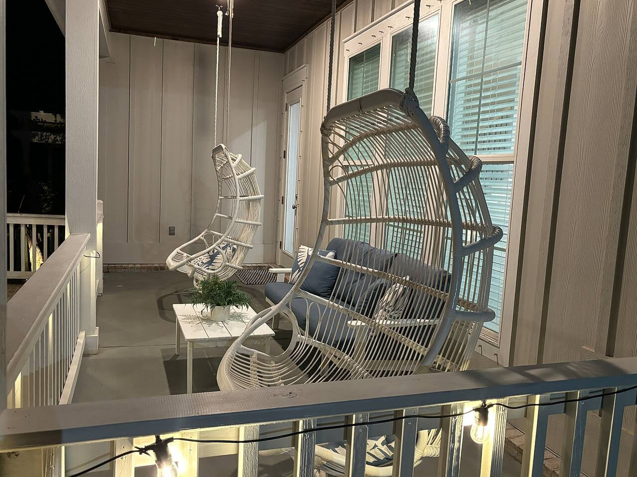 Chill out in hanging chairs on this cozy lit porch—your perfect spot for peaceful vibes.