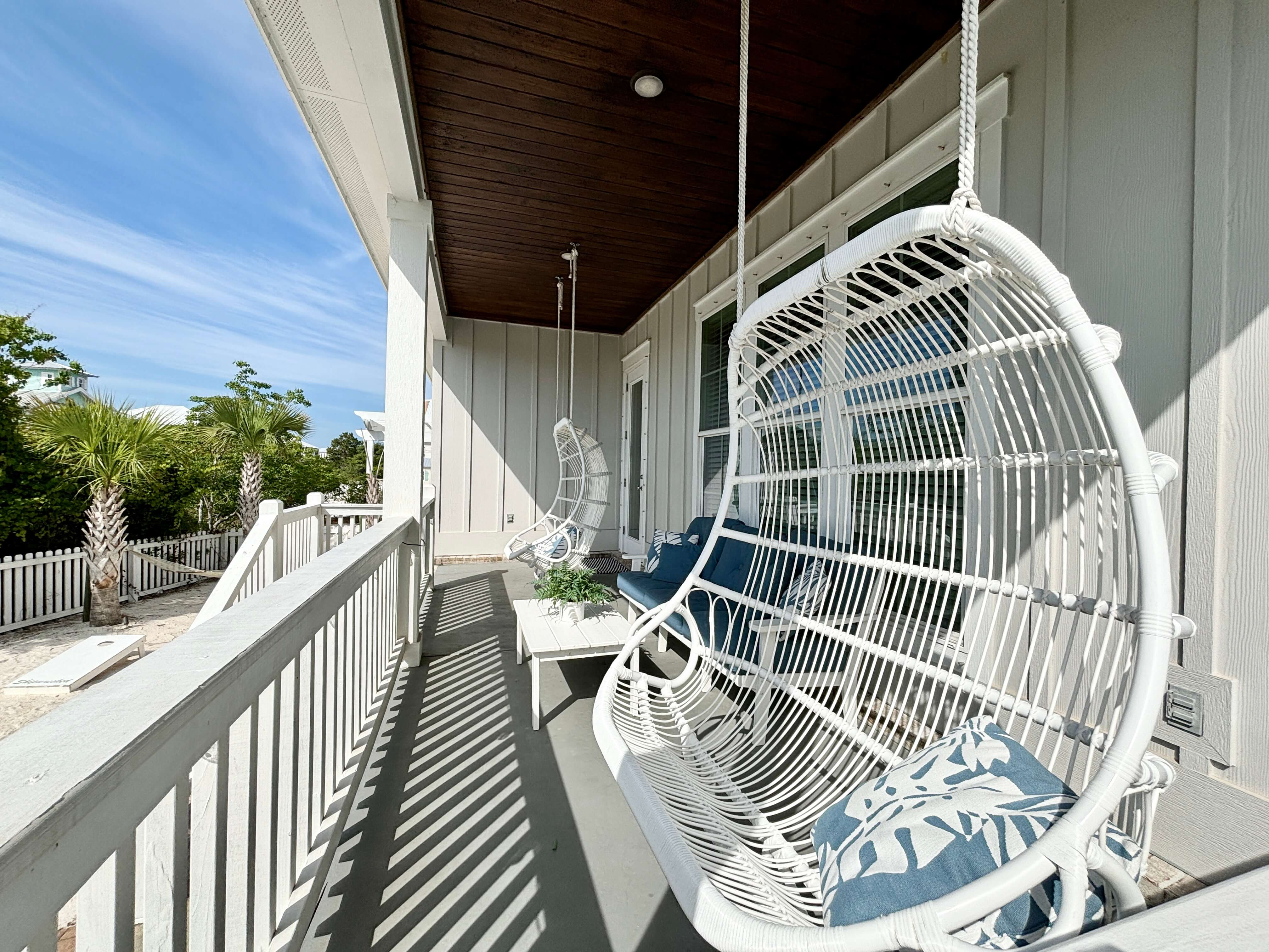 Catch the gentle ocean breeze from comfortable hanging chairs at this luxury property.