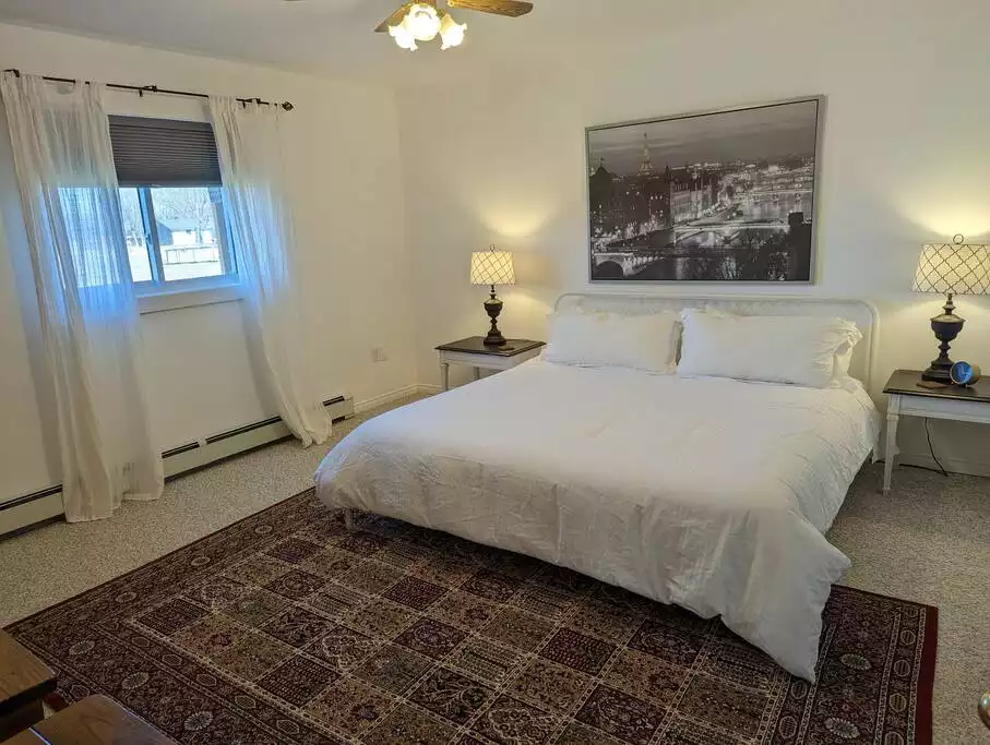 The king room is very large and has an armoire to store away your belongings. It has black out curtains and overlooks our yard and our neighbours picturesque barns. - Family Friendly Suite with Arcade and Park Pass - Prince Edward