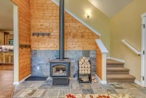 Cozy wood stove.  A small stack of wood is provided.