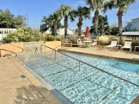Gorgeous, zero-entry community pool and hot tub, which sits on the bank of the canal.