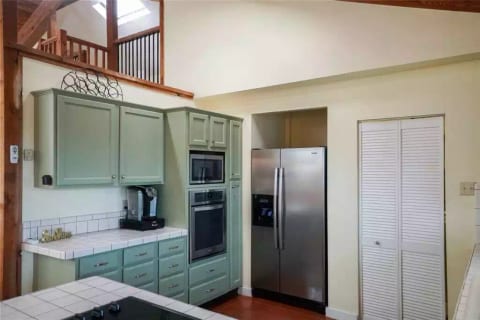 The kitchen has a keurig machine, as well as a drip coffee maker and a french press. It's a well appointment kitchen with all you need to bake, boil and broil. There is a washer/dryer and pantry behind the white door.