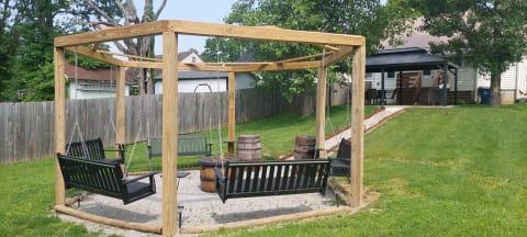 Outside patio swing/firepit area with pavilion.