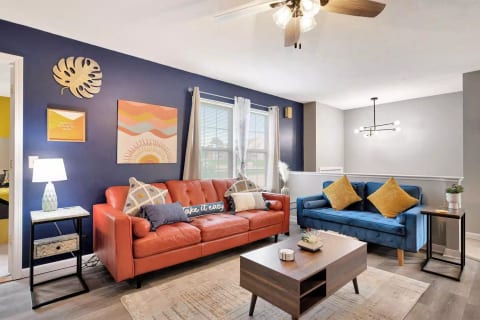 Orange couch can be used to sleep on for one person