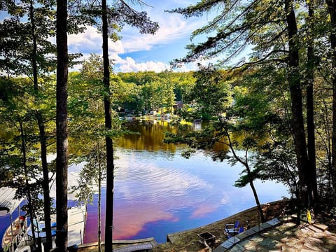 Huge deck with umbrella seating and hot tub, newly installed patio, great sandy beach with fire pit, huge dock with sunbathing loungers and stunning views!!