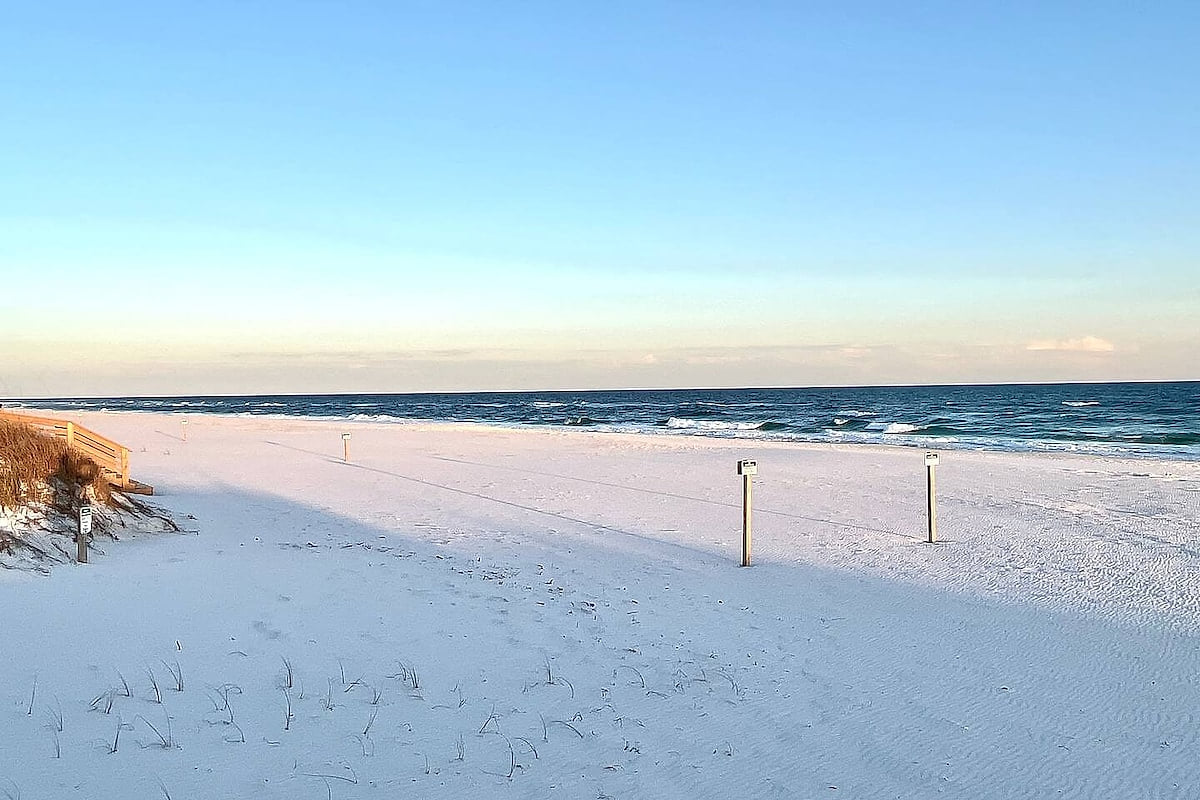 Serene sugar-white beach with gentle waves and endless gulf views Modern Luxury 4BR in Perdido Key - Walk to Beach