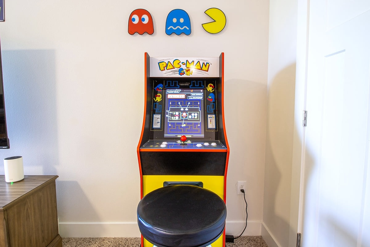 Retro Pac‑Man arcade with stool—fun game-room perk for all ages