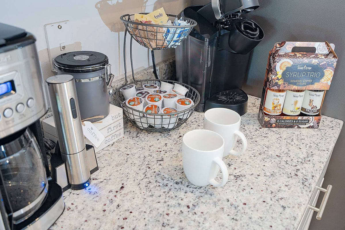 Well-stocked coffee bar with Keurig, drip brewer, pods & syrups