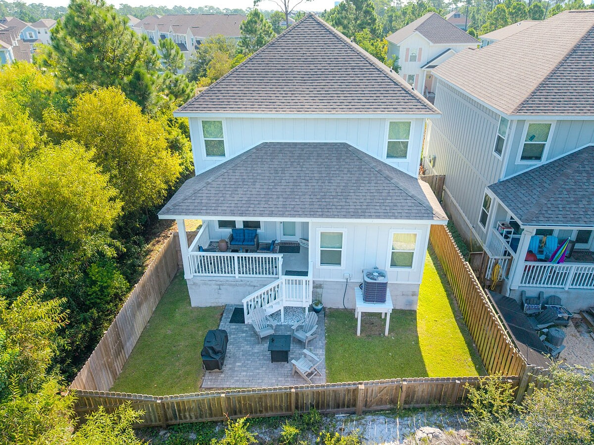 Fenced backyard oasis with covered porch, patio & fire pit