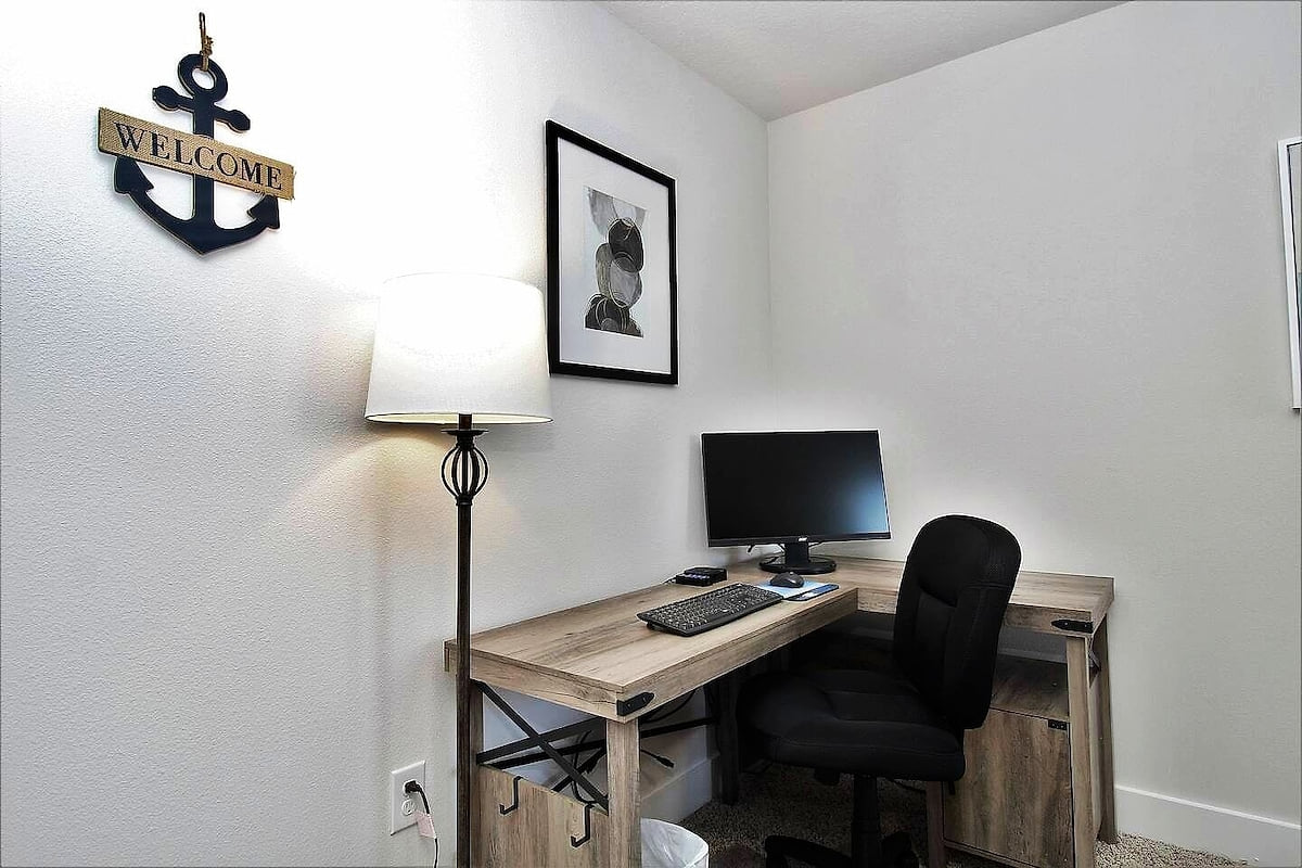 Quiet home office with monitor, L-desk & comfy chair—WFH ready