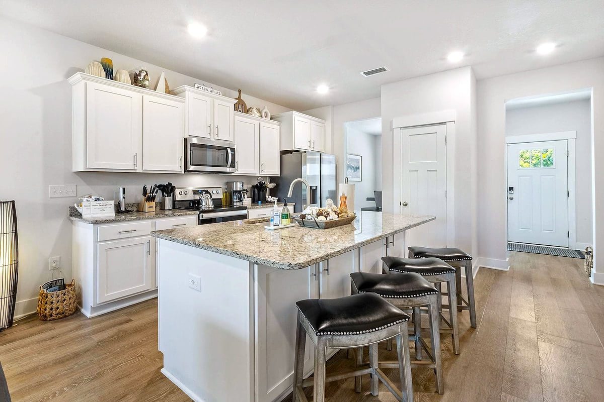 Bright gourmet kitchen: granite island, 4 bar seats, stainless appliances. Modern Luxury 4BR in Perdido Key - Walk to Beach